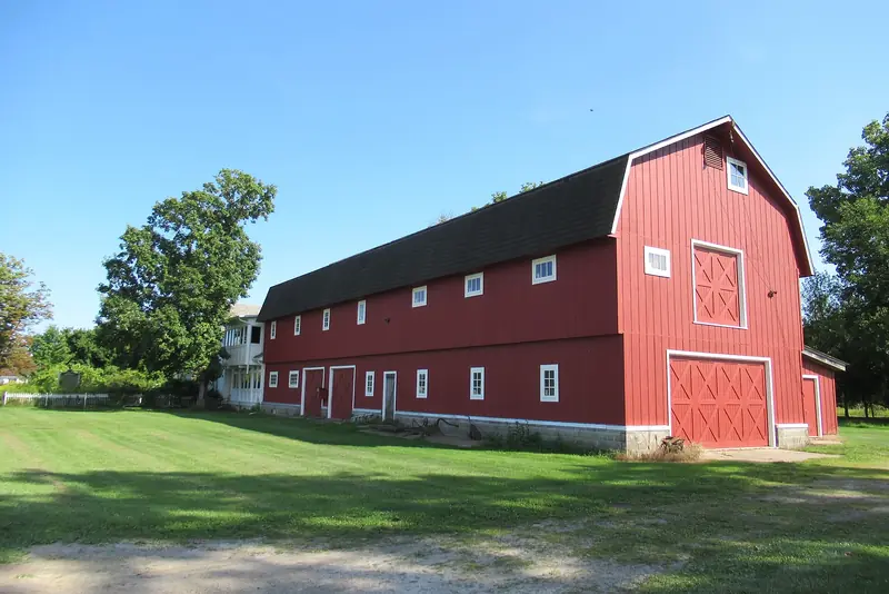 A farmstead on Harsens Island in St. Clair County. Plot ground on parcels like this starts the same way: cleared and mulched before anything is planted.