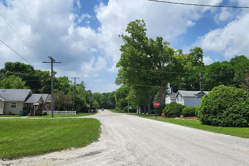 A gravel road through the woods in Clyde Township: the kind of corridor that closes in a few feet a year.