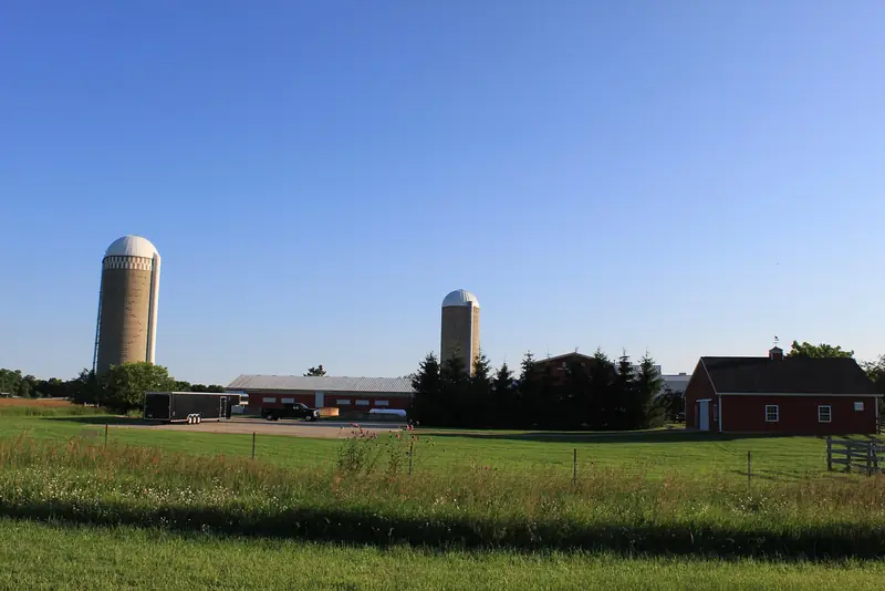 A Manchester Township farm: big fields, a woodlot in the corner, and the edge the woods keep pushing outward.