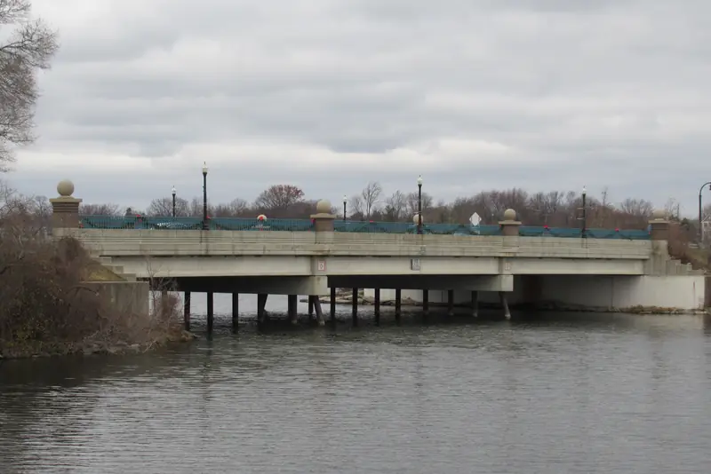 The bridge over Belleville Lake at the City of Belleville. Lake banks here grow buckthorn and grapevine within a few unmowed seasons.